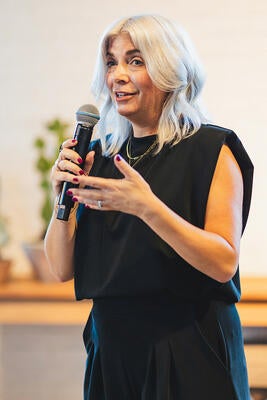 Ellie Sanchez welcomes guests to the event